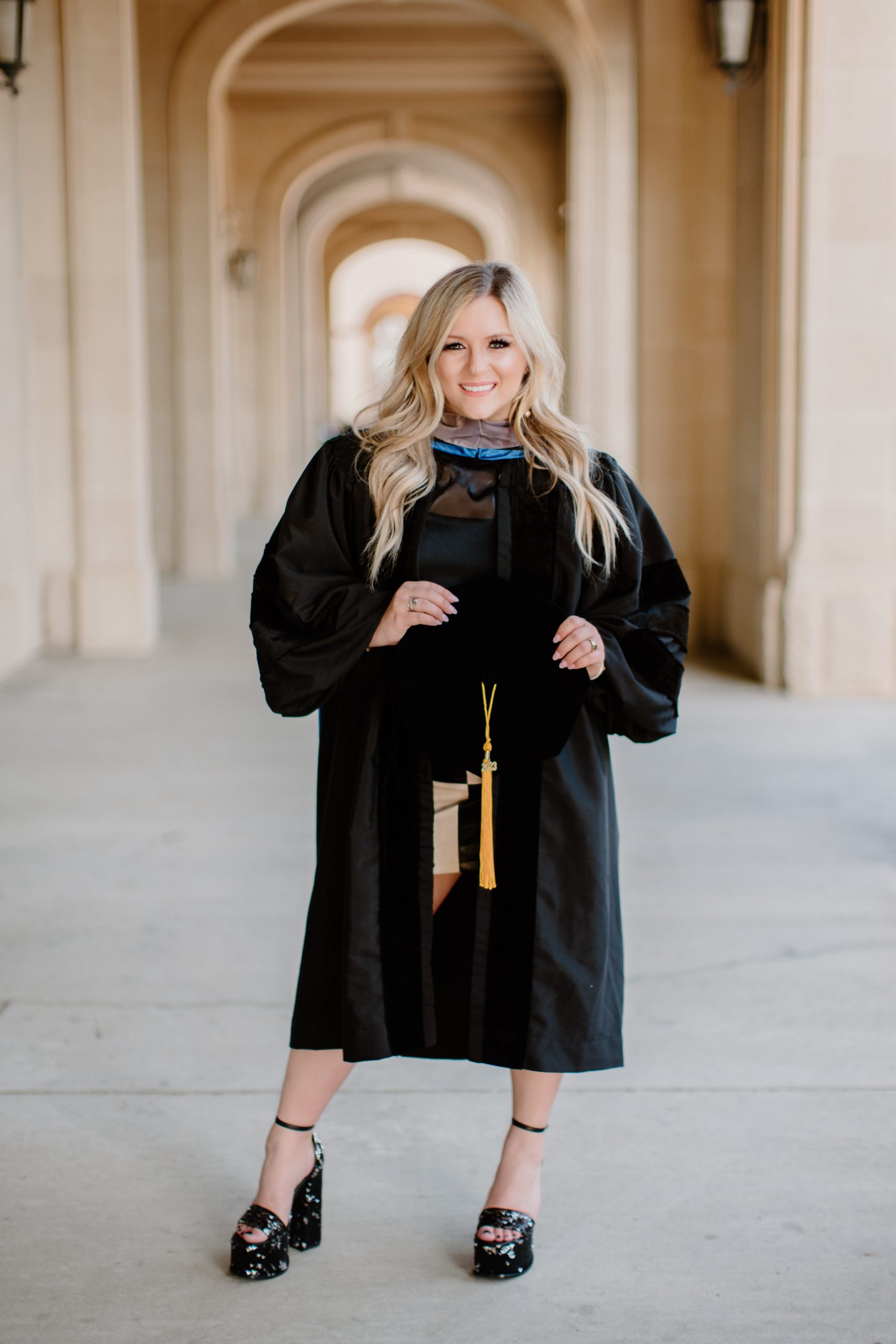 Dr. Kennedy Adams poses for a photo in her graduation gown.